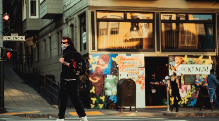 How To Choose A Long Range Electric Skateboard man in black jacket and black pants walking on pedestrian lane during daytime