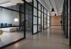 Revolutionizing Creative Spaces: Production Houses Meet Workplace Design hallway between glass-panel doors