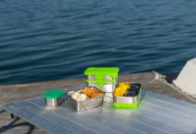 Choosing the Best Eco-Friendly Food Containers for the Green Packaging Revolution a picnic table with food on it near a body of water