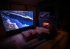 How Physical Play Is Changing Home Entertainment A person sitting on a couch in front of a flat screen TV