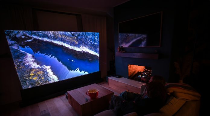 How Physical Play Is Changing Home Entertainment A person sitting on a couch in front of a flat screen TV