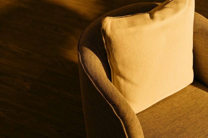 Photo by Redd Francisco a close up of a cushion on a chair