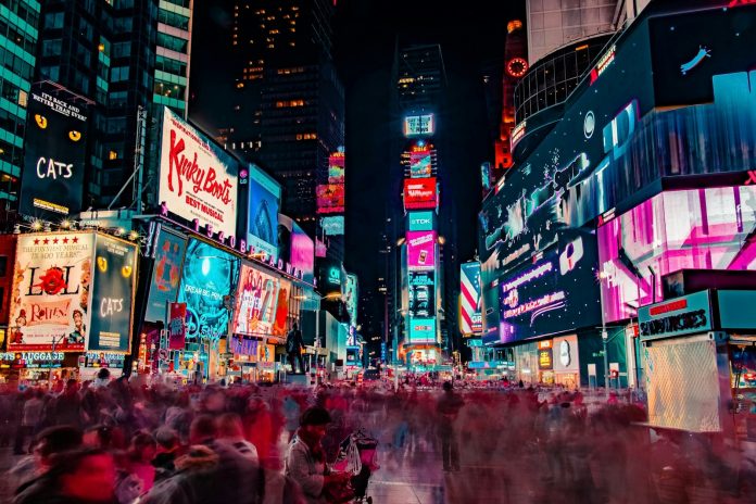 Photo by Joe Yates time-lapse photography of crowd of people on New York Time square during night time